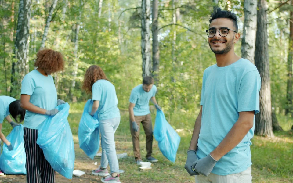 Volunteers collecting litter in a park.