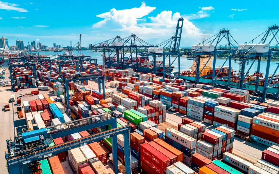 Shipping containers and cranes at a cargo port.