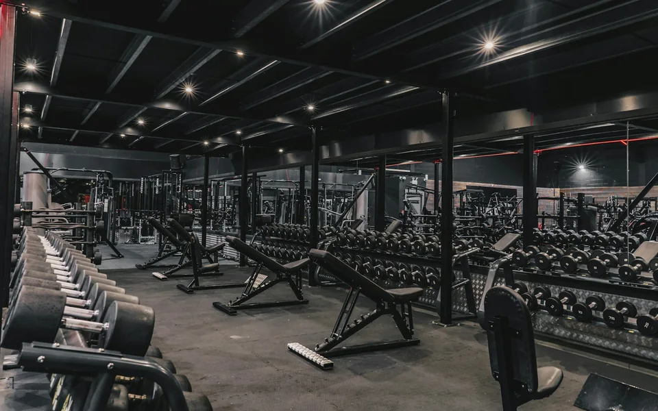 Exercise machines and weights inside a fitness studio.