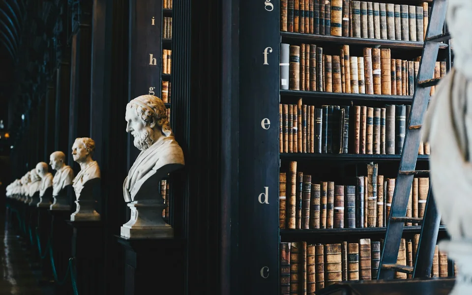 Bookshelves filled with reference books in a library.