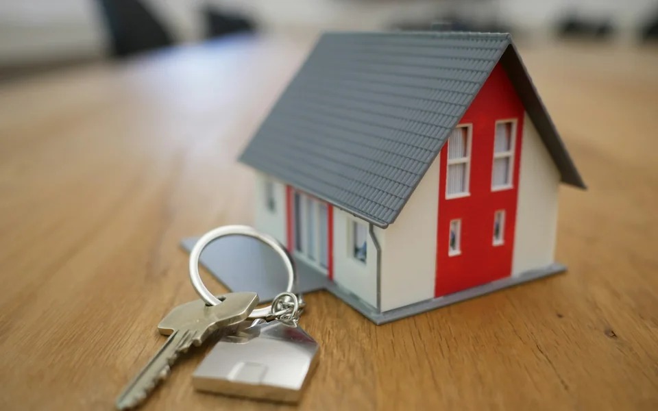 House keys beside a model home.