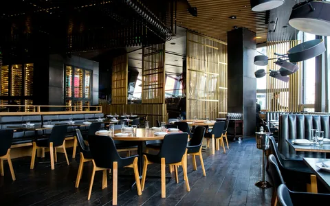 Dining tables and seating inside a restaurant.