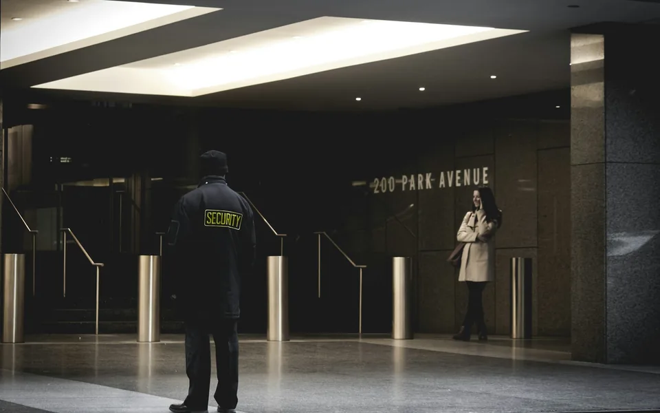 Security guard standing near an entrance.