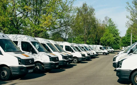 A fleet of delivery vans parked side by side.
