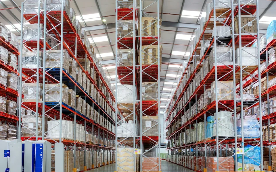 Rows of tall storage racks inside a warehouse.